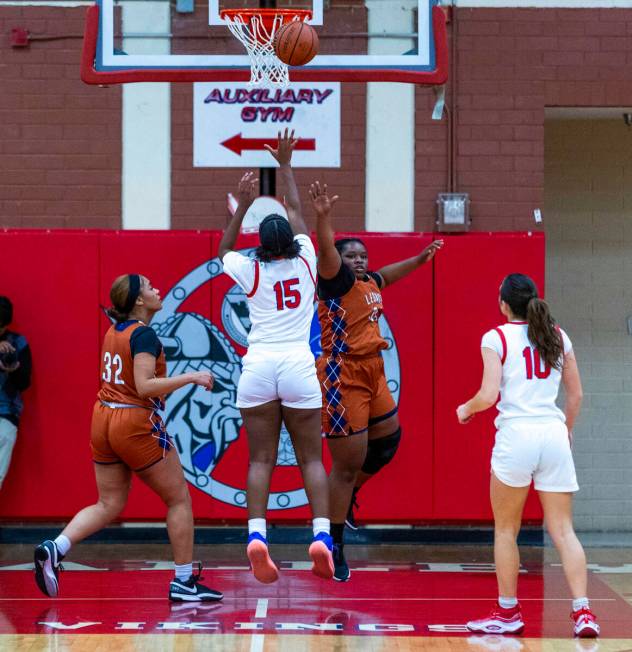 Valley's Laneice Rodgers (15) takes a shot past Legacy's Iyanais Vincent (34) and Ajalee Willia ...