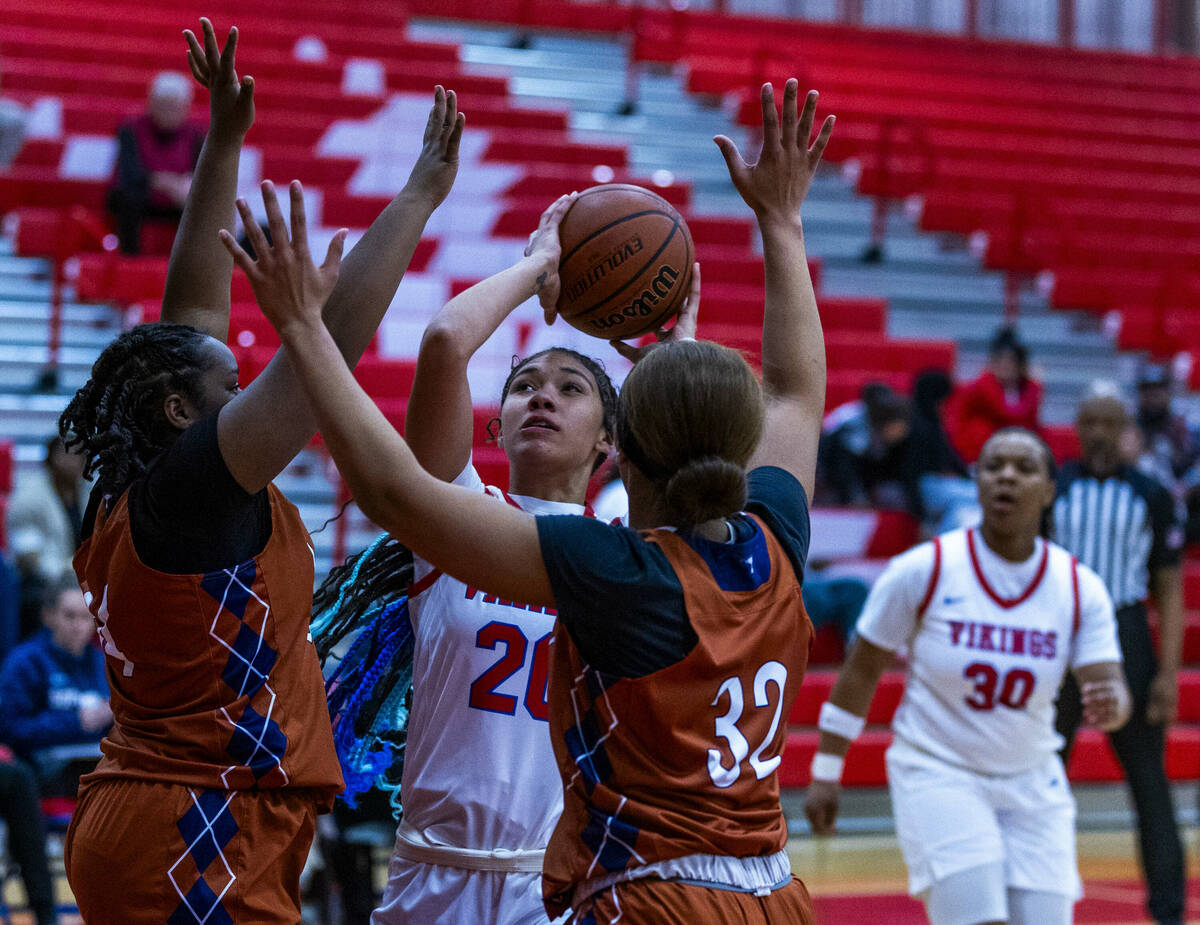 Valley's Jennifer Hughes (20) looks to shoot against Legacy's Ajalee Williams (32) and teammate ...