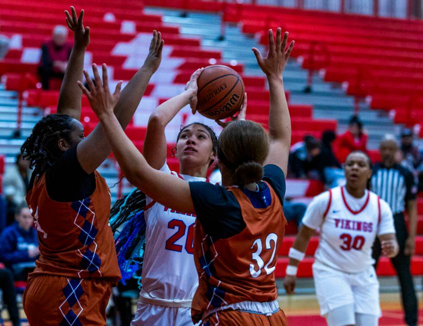 Valley's Jennifer Hughes (20) looks to shoot against Legacy's Ajalee Williams (32) and teammate ...