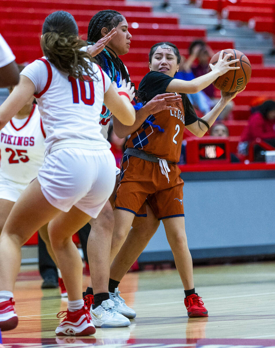 Legacy's Shalena Mesiona (2) keeps the ball from Valley's Jennifer Hughes (20) and Quinn Steidl ...