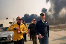 California Gov. Gavin Newsom, right, tours the downtown business district of Pacific Palisades ...