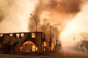 FILE - A structure on Lake Avenue is engulfed in flames, Jan. 8, 2025, in the Altadena section ...