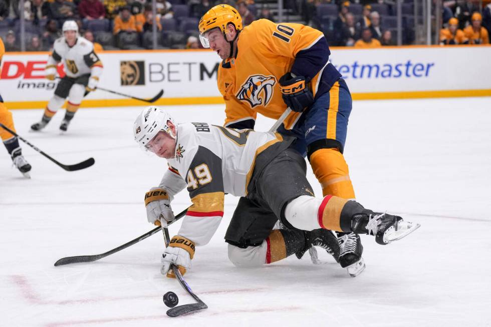 Vegas Golden Knights center Ivan Barbashev (49) hits the puck past Nashville Predators center C ...