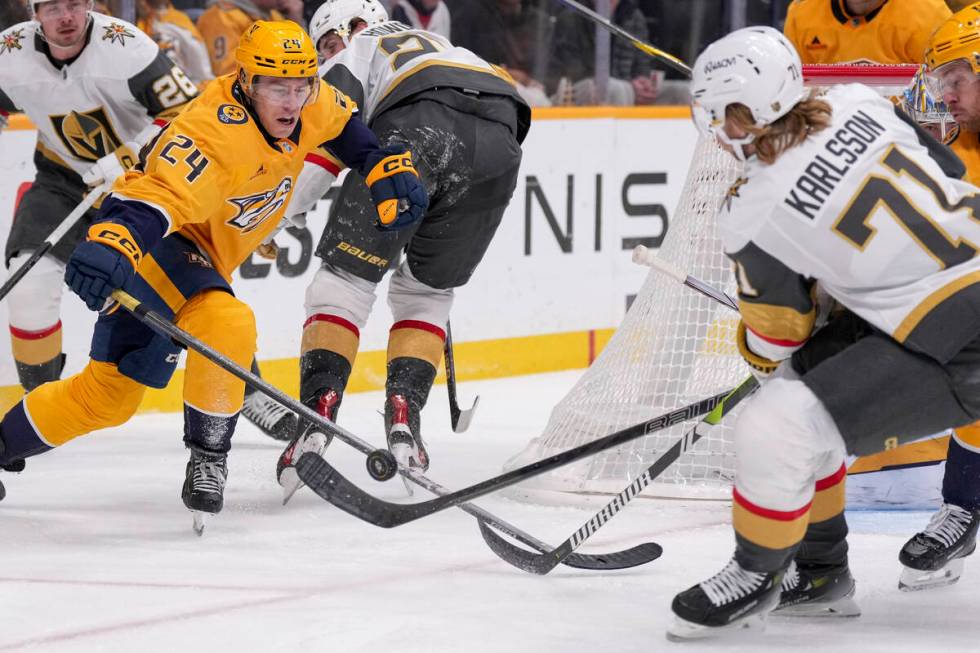 Nashville Predators defenseman Spencer Stastney (24) hits the puck past Vegas Golden Knights ce ...