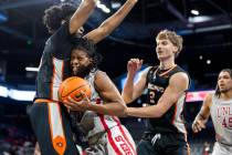 UNLV guard Jaden Henley, right, runs into Pacific Tigers center Jazz Gardner, left, during the ...