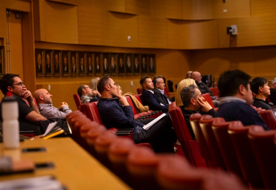 Residents of Queensridge and others listen to a representative of home developer Lennar speak b ...