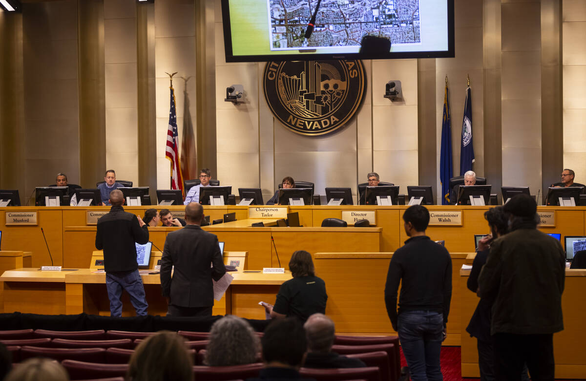 People line up to speak against a proposed housing development at the former Badlands golf cour ...