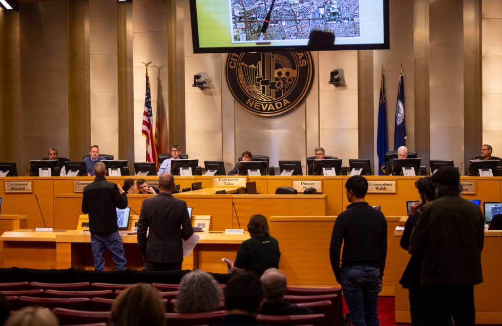 People line up to speak against a proposed housing development at the former Badlands golf cour ...