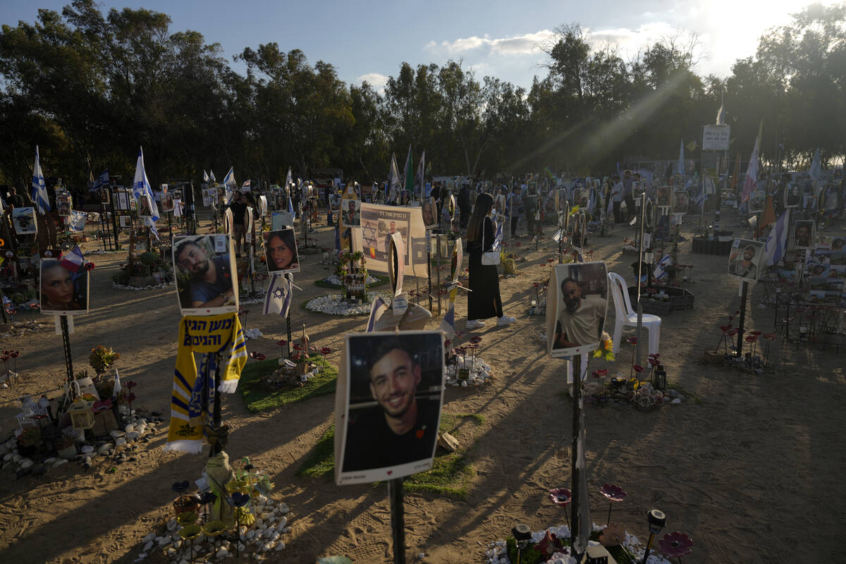 People visit the site of the Nova music festival, where hundreds of revelers were killed and ab ...