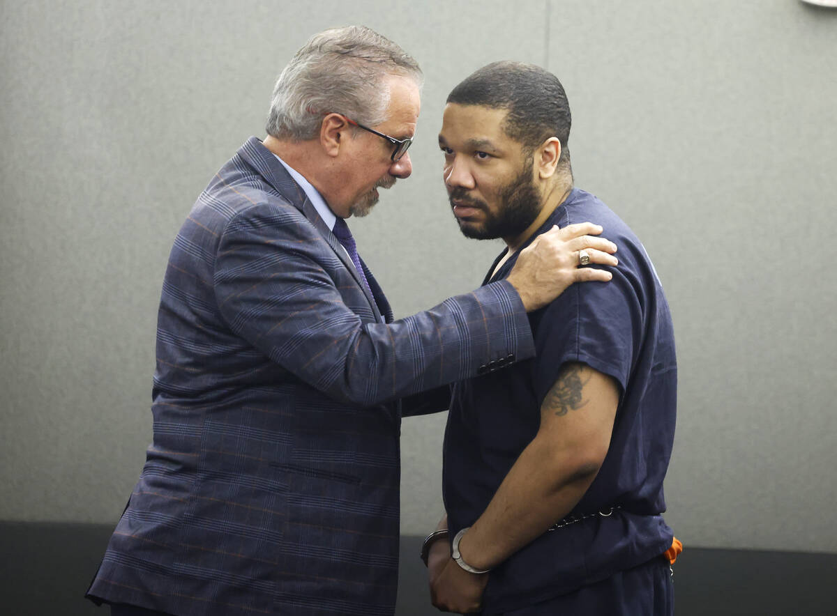 Attorney Ozzie Fumo, left, comforts his client Julius Trotter, who was found guilty of breaking ...