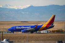 Southwest Airlines jetliner taxis down a runway for take off at Denver International Airport, T ...