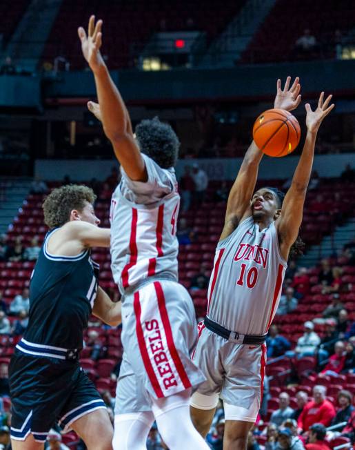 UNLV guard Jaden Henley (10) blocks a pass by Utah State Aggies guard Mason Falslev (12) during ...