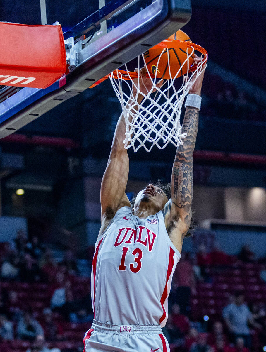 UNLV guard Brooklyn Hicks (13) dunks the ball over the Utah State Aggies during the first half ...