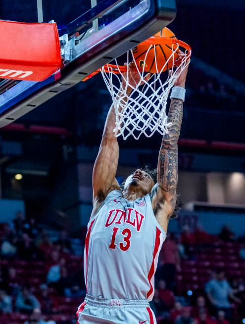 UNLV guard Brooklyn Hicks (13) dunks the ball over the Utah State Aggies during the first half ...