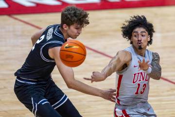 UNLV guard Brooklyn Hicks (13) tosses a pass away from Utah State Aggies forward Tucker Anderso ...