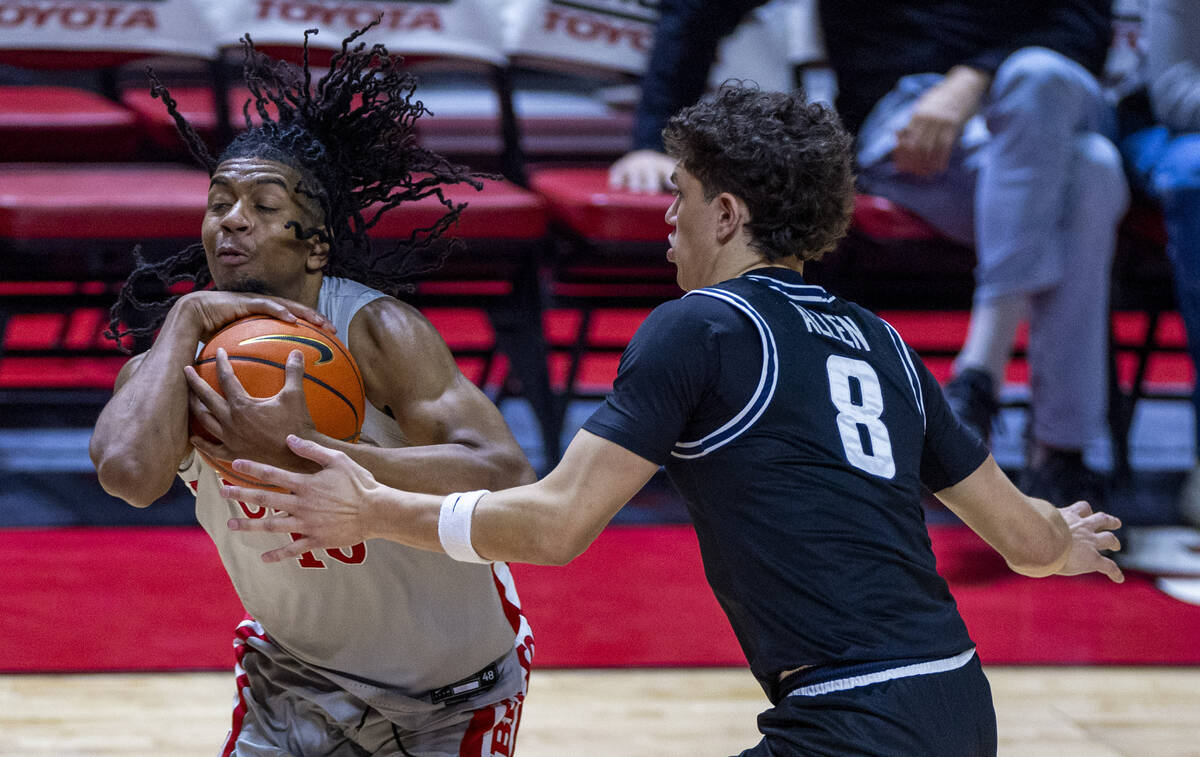 UNLV guard Jaden Henley (10) is fouled on a drive by Utah State Aggies guard Drake Allen (8) du ...