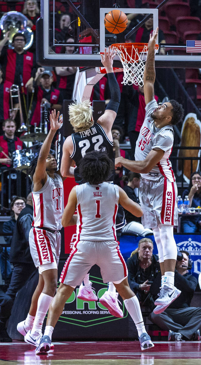 Utah State Aggies forward Karson Templin (22) attempts to lay the ball in as UNLV forward Jerem ...