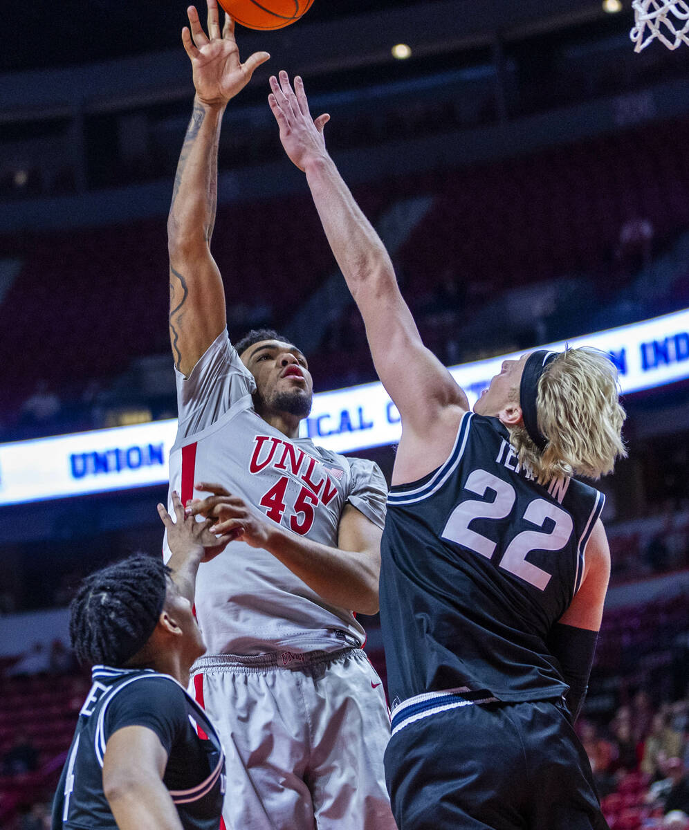 UNLV forward Jeremiah Cherry (45) shoots over Utah State Aggies forward Karson Templin (22) for ...