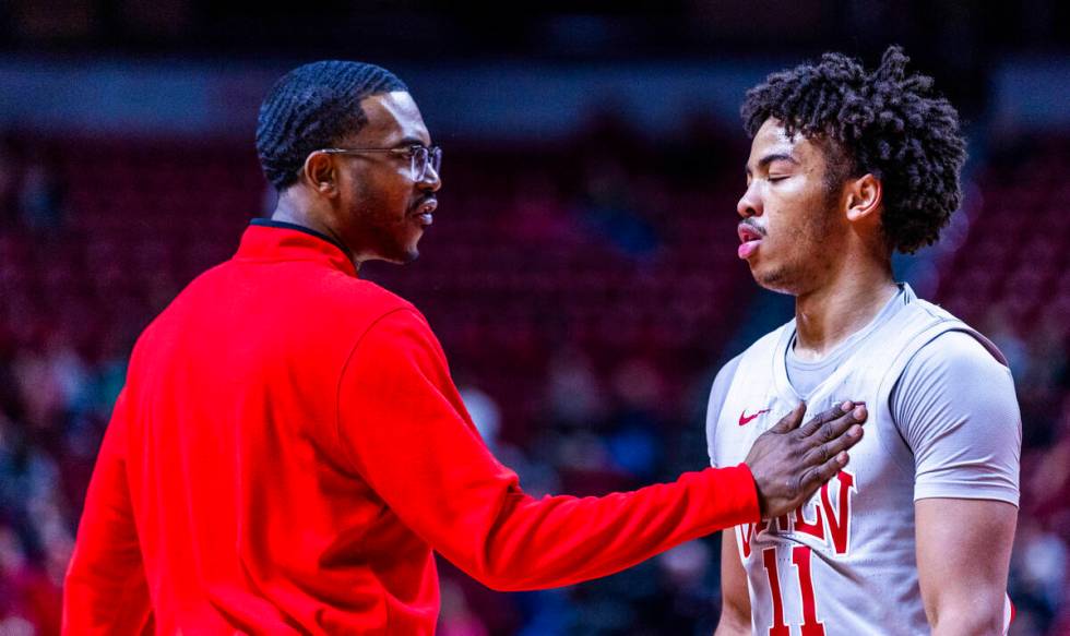 UNLV guard Dedan Thomas Jr. (11) is calmed down by a coach during a time out against the Utah S ...