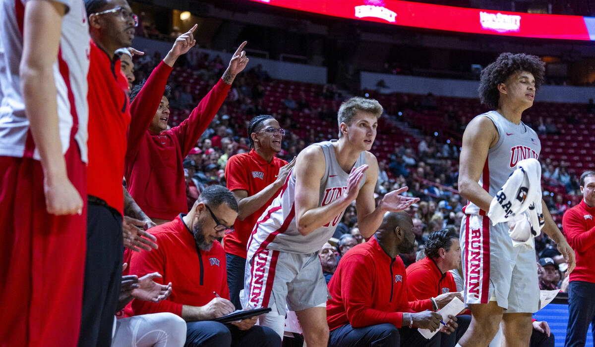 The UNLV bench cheers the team on against the Utah State Aggies during the second half of their ...