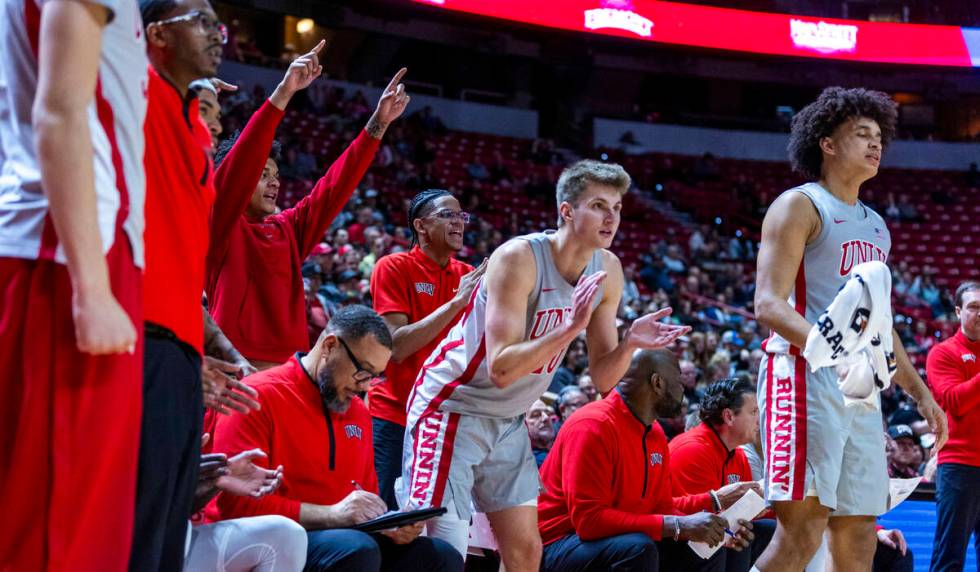 The UNLV bench cheers the team on against the Utah State Aggies during the second half of their ...