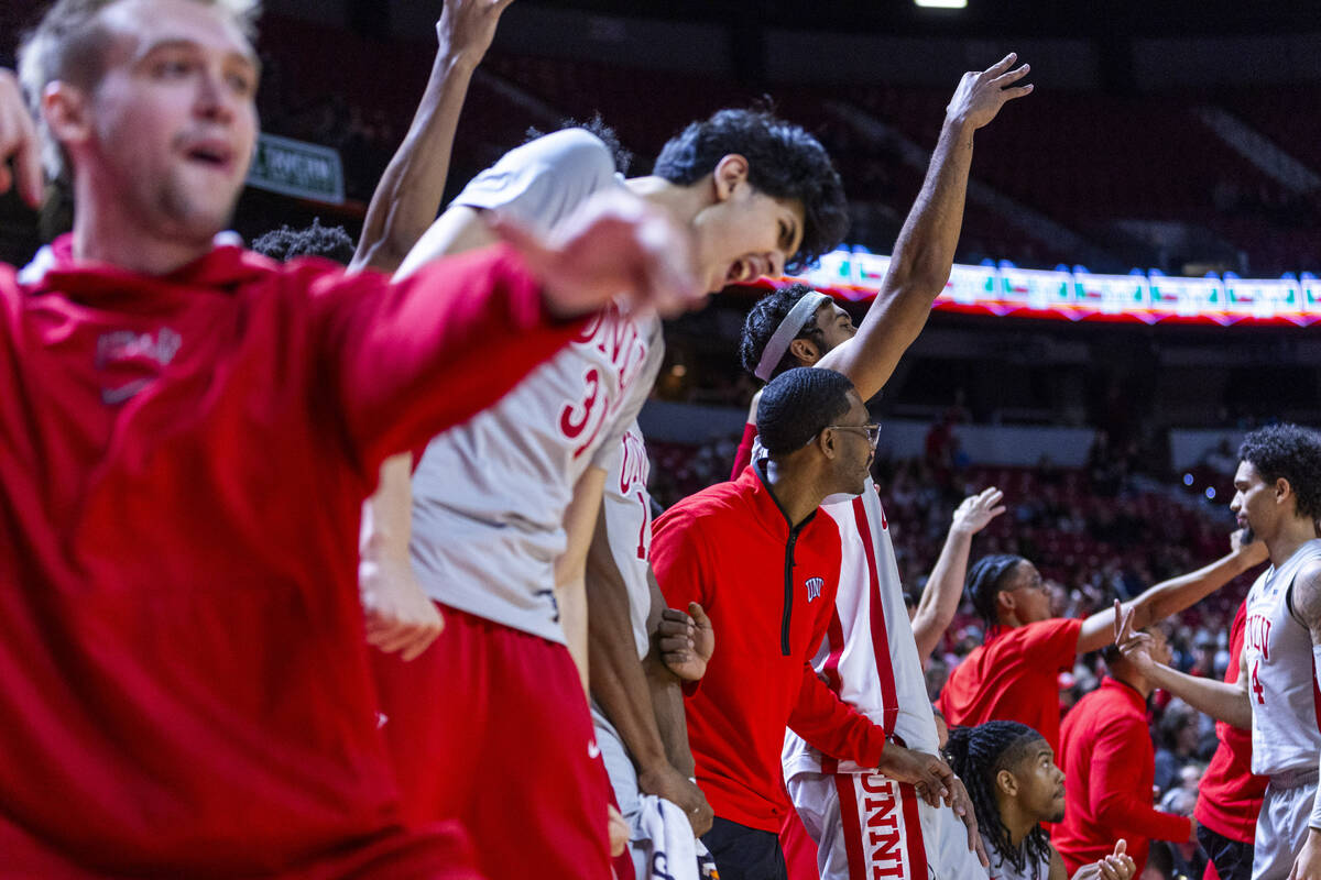 The UNLV bench cheers the team on after a three-point basket against the Utah State Aggies duri ...