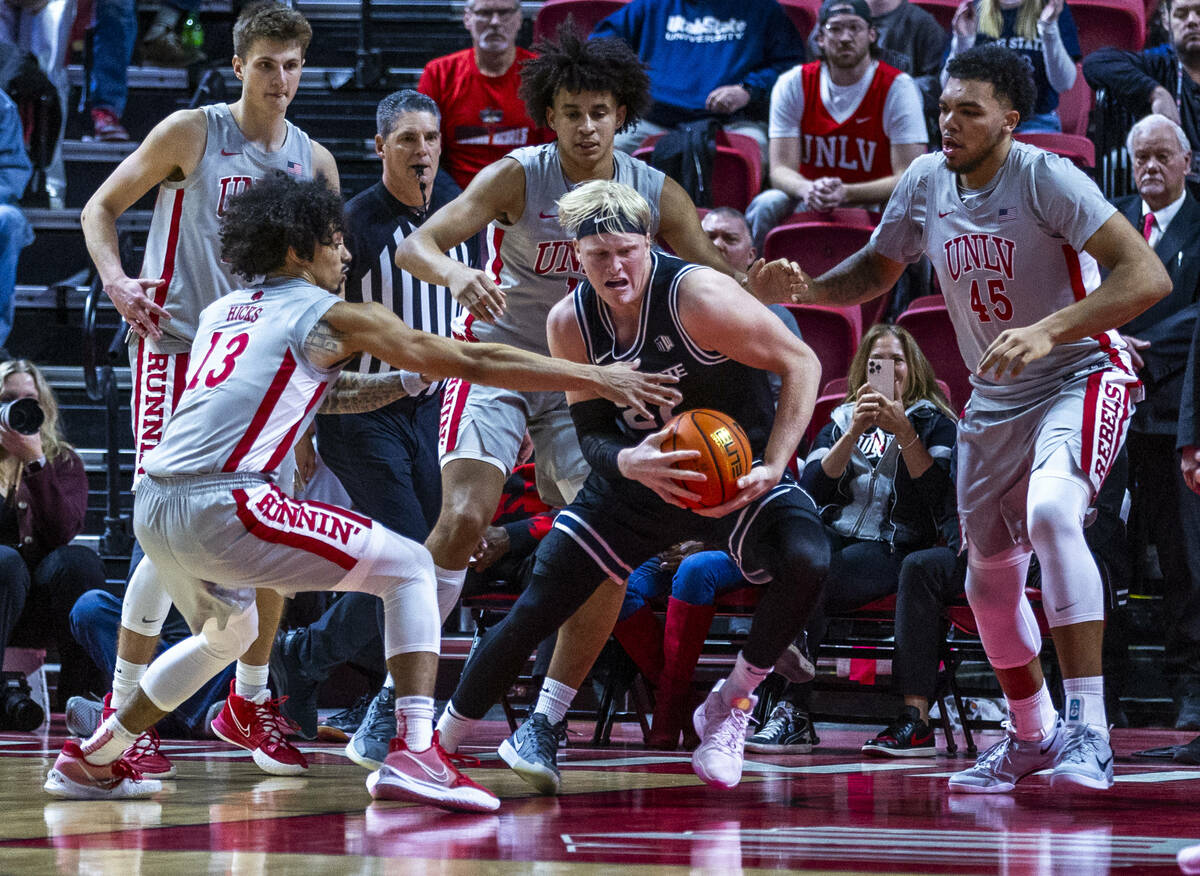 UNLV guard Brooklyn Hicks (13) looks to grab the ball from Utah State Aggies forward Karson Tem ...