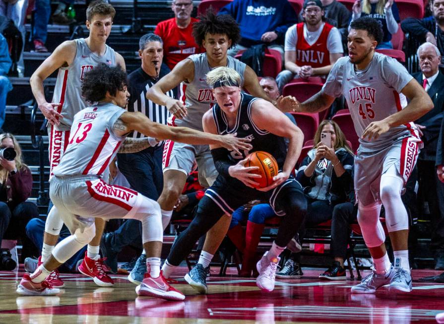 UNLV guard Brooklyn Hicks (13) looks to grab the ball from Utah State Aggies forward Karson Tem ...