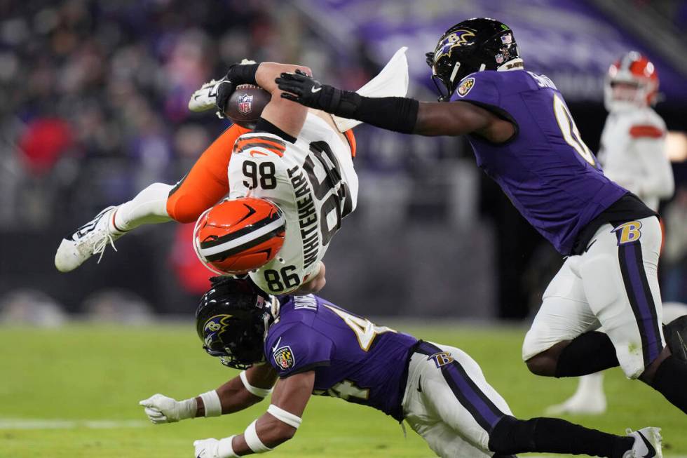 Cleveland Browns tight end Blake Whiteheart (86) is upended by Baltimore Ravens cornerback Marl ...