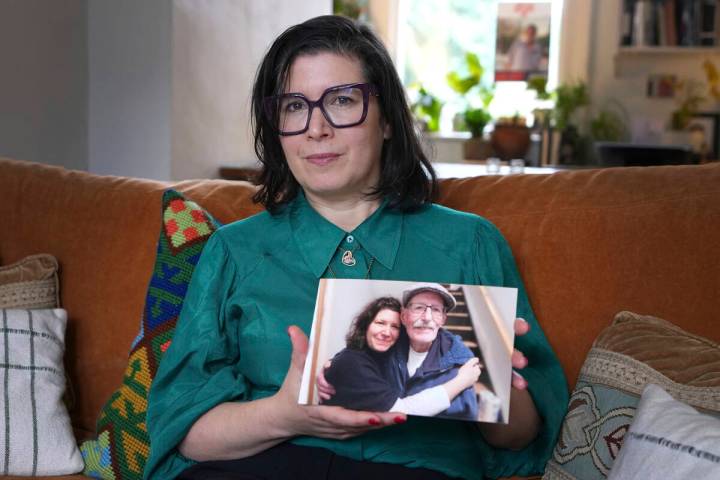 Sharone Lifschitz holds a photograph of herself with her father, Oded Lifshitz, who was abducte ...