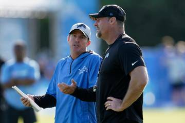 Detroit Lions offensive coordinator Ben Johnson, left, talks with head coach Dan Campbell durin ...