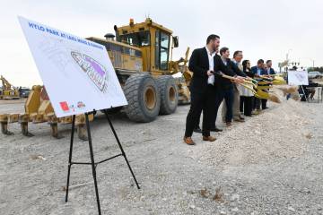 Developers and politicians toss a shovel of dirt during a ceremonial groundbreaking for the Hyl ...