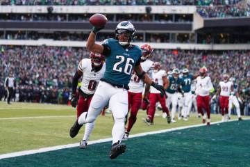 Philadelphia Eagles running back Saquon Barkley (26) scores a touchdown as Washington Commander ...