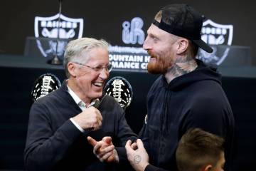 The new Raiders head coach Pete Carroll, left, and defensive end Max Crosby share laughter afte ...