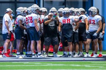 UNLV defensive line coach Ricky Logo works with his players during football practice at the Int ...