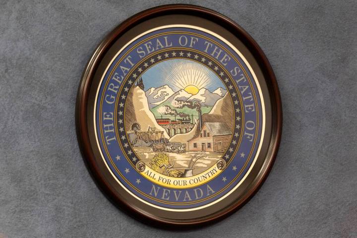 The Great Seal of the State of Nevada is hung on a wall in the Nevada Legislature building duri ...