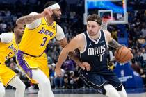 FILE - Dallas Mavericks guard Luka Doncic drives against Los Angeles Lakers forward Anthony Dav ...