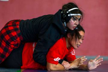 Mika Yoffee has an advantage position atop of Libardi Barcena during girl's wrestling practice ...