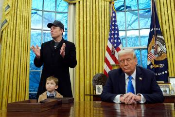 President Donald Trump listens as Elon Musk, with his son X Æ A-Xii, speaks in the Oval Of ...