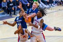 Centennial's Cooper Jenkins (30)battles for a rebound with Bishop Gorman's Jett Washington (2) ...