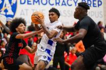 Democracy Prep forward Dion Parker (middle) glides through the Mater East defense dur ...