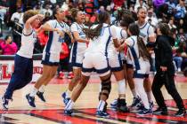 Centennial teammates celebrate winning a class 5A girls basketball state championship game betw ...