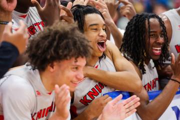 Mater East players celebrate winning a class 3A boys basketball state championship game between ...