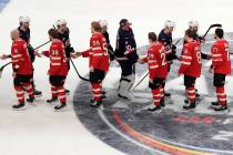 Canada, bottom, and United States, top, players shake hands following an overtime period of the ...