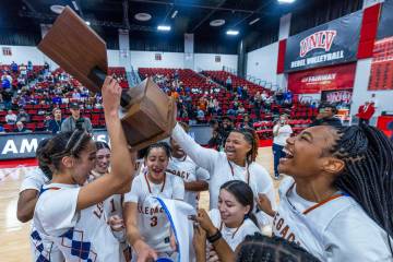 Legacy teammates celebrate their win over Reno during their 4A girls basketball state champions ...