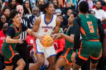 Bishop Gorman wing Jett Washington (2) looks for an open teammate during a class 5A boys basket ...