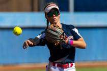 Coronado runner Bailey Goldberg (1) tosses the ball to first base against a Douglas runner duri ...