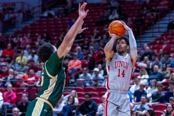 UNLV guard Jailen Bedford (14) lines ups a shot over Colorado State Rams guard Jalen Lake (15) ...