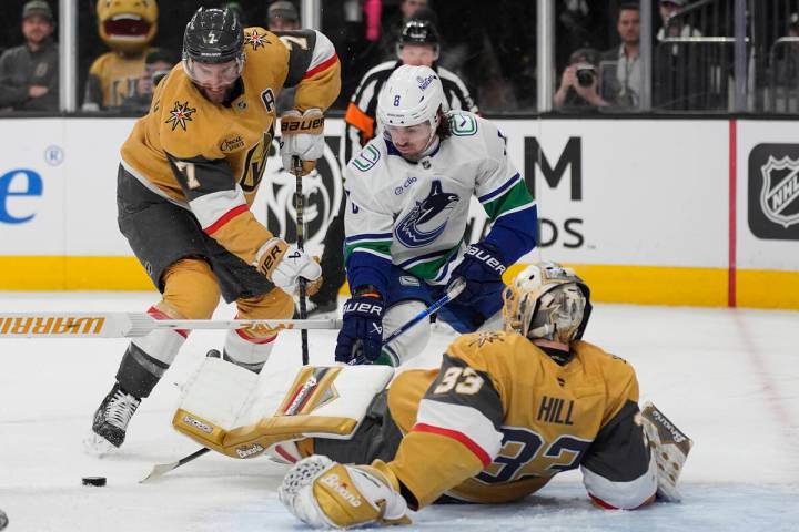 Vancouver Canucks right wing Conor Garland (8) attempts a shot on Vegas Golden Knights goaltend ...