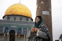 A woman prays at the Al-Aqsa Mosque compound during the first Friday Prayers of the Muslim holy ...